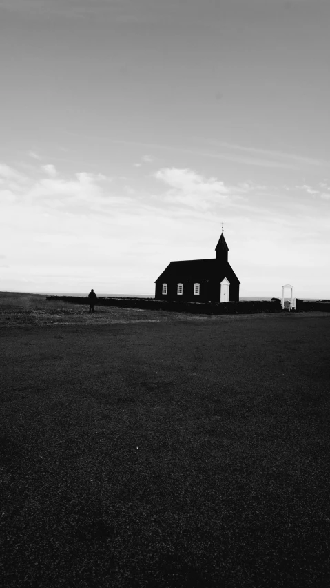 a black and white po of a church in the country