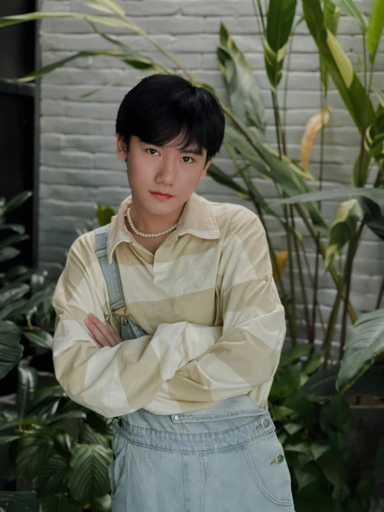 a boy poses for a portrait in a park