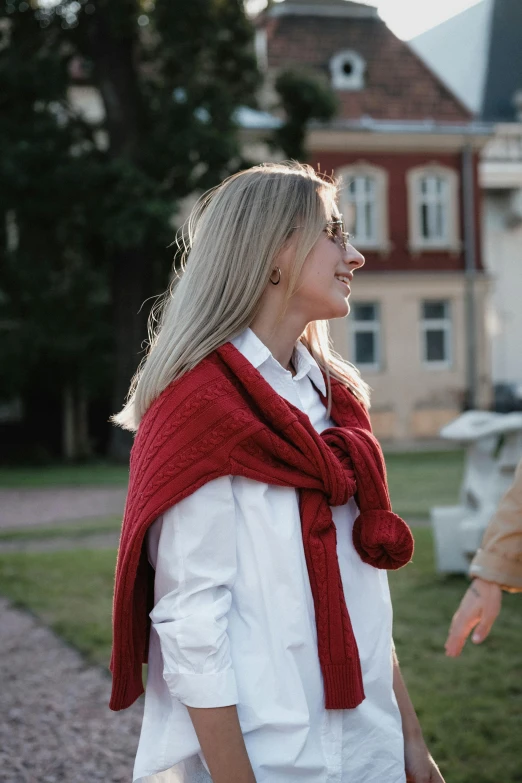 an older woman wearing a red scarf