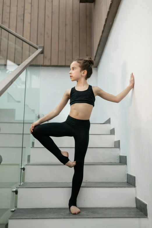 a  standing on some steps wearing black