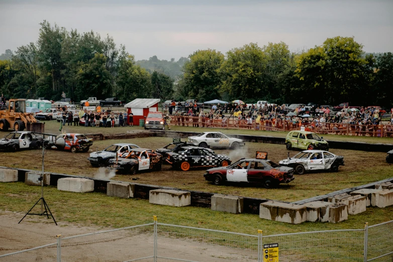 several vehicles driving around in an outdoor course