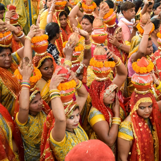 a group of women wearing colorful attire standing next to each other