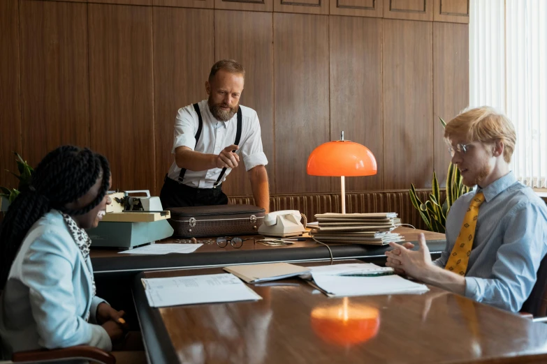 two women and one man are working at the desk in a restaurant