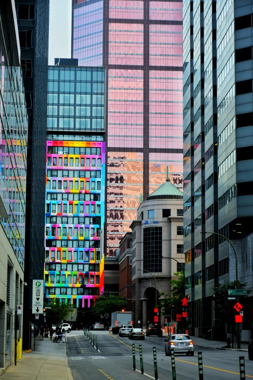 several colorful windows in the back of buildings on a city street