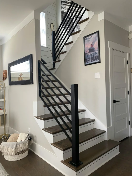 a stair case with wood flooring and metal handrails