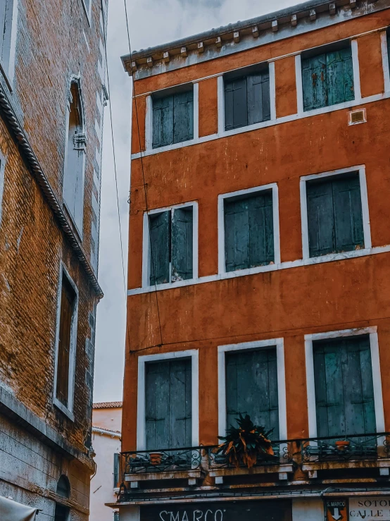 a group of buildings that have windows with black trim