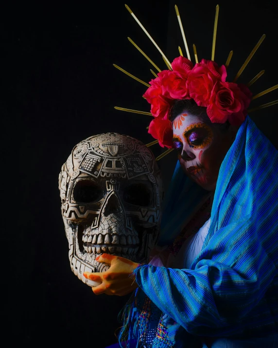 a woman in an elaborately painted skull poses with a doll