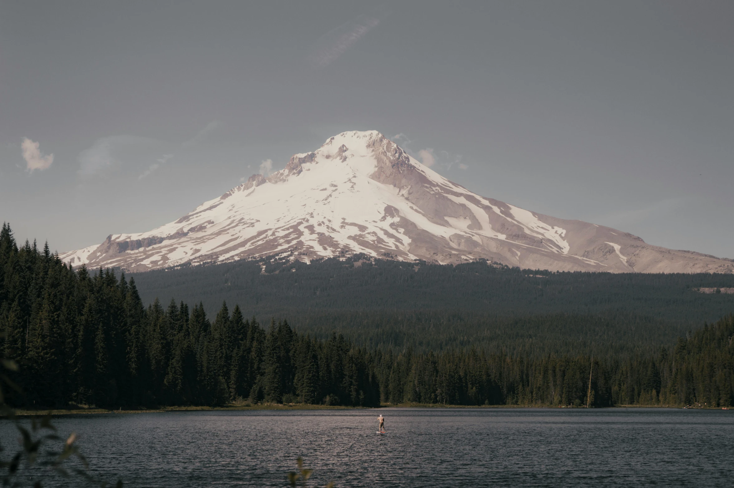 the mountain is in the distance with trees around it