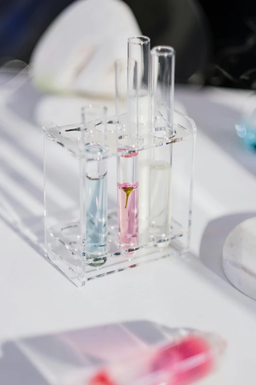 small clear containers holding colored liquids on table