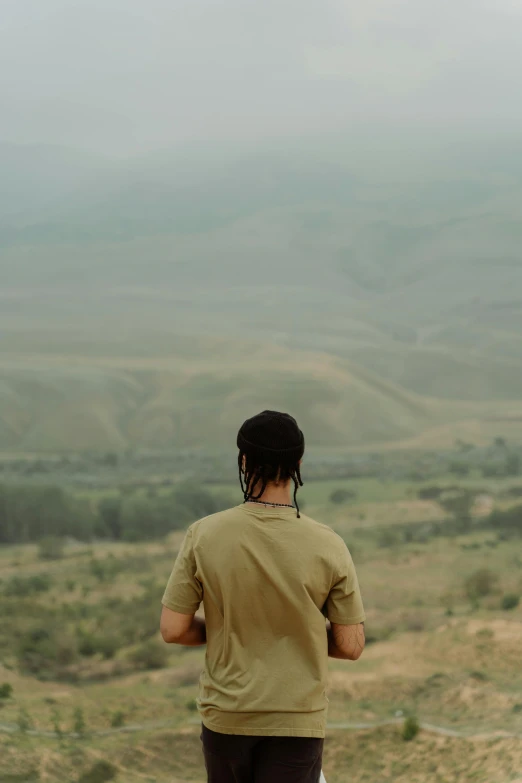 a man that is standing on the top of a hill