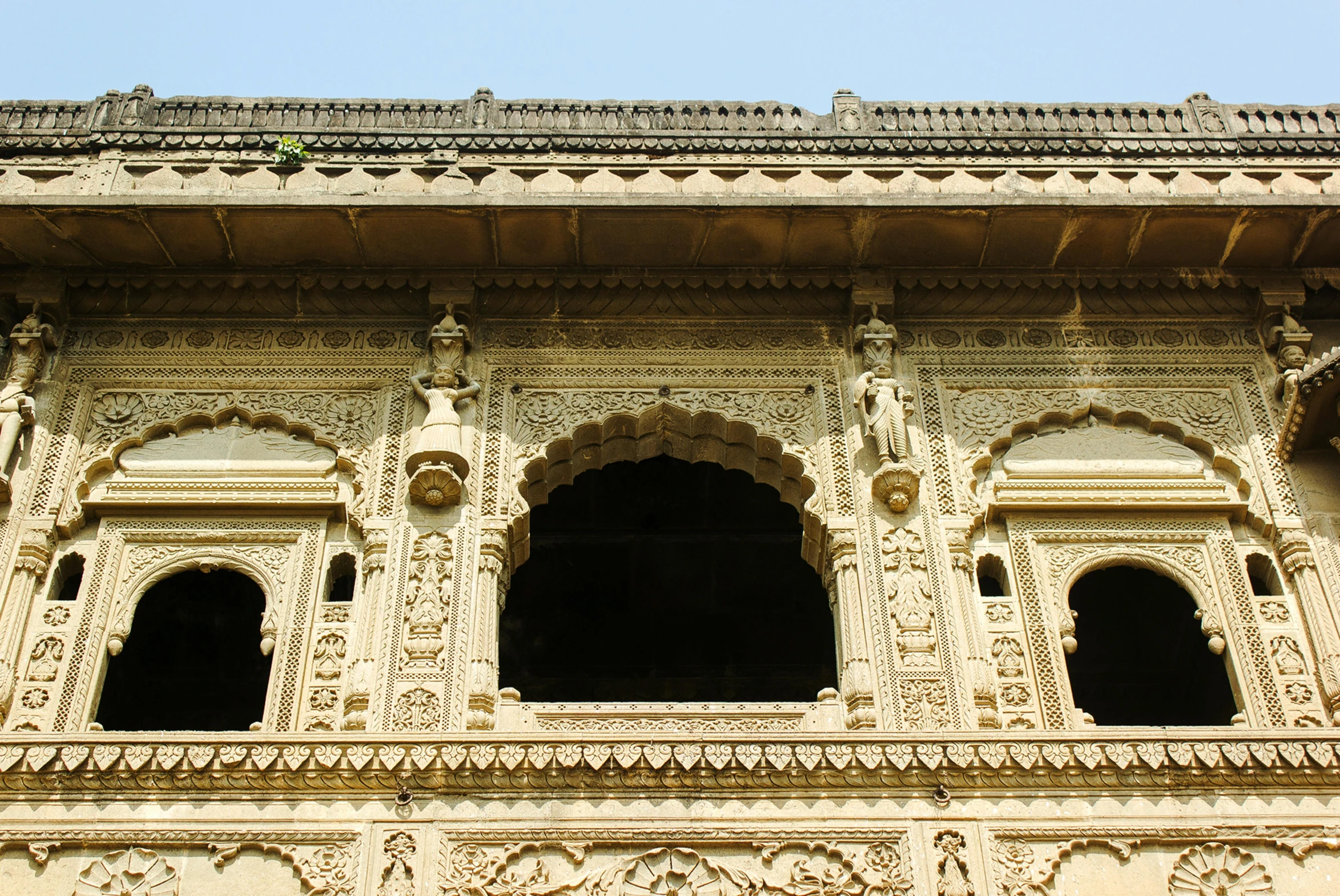 a window that has statues and carvings on the outside