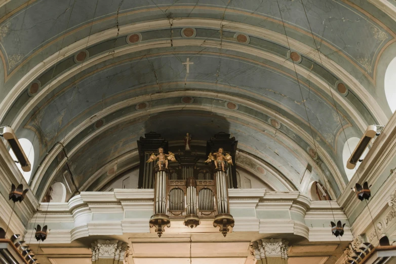 the inside of a church with an organ in it