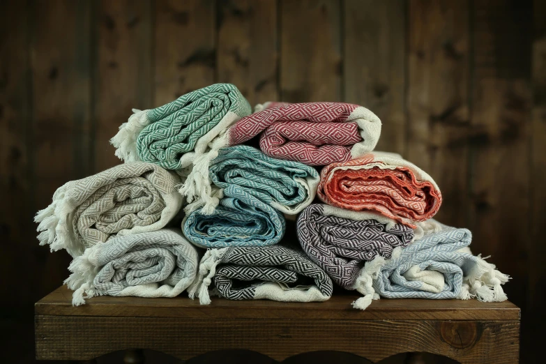 a pile of different colors of cloth on a table