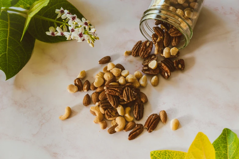 seeds and nuts are scattered around a jar