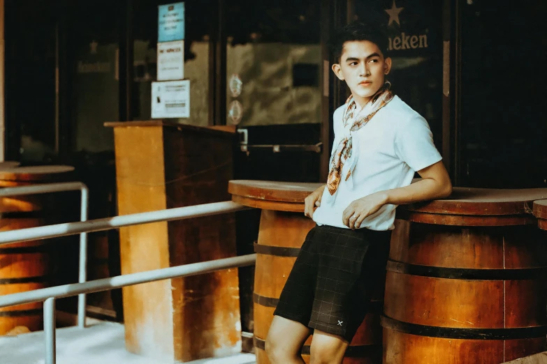 the young man is posing for the camera in front of an old - fashioned restaurant