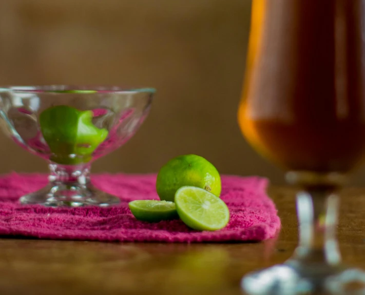 two glasses of juice and one with limes