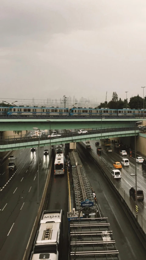 a traffic jam with trains and cars on an overpass