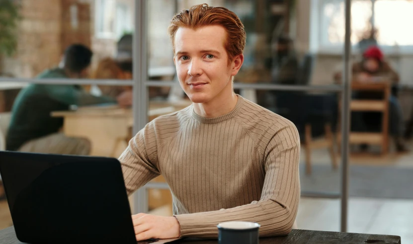 man using laptop in a coffee shop