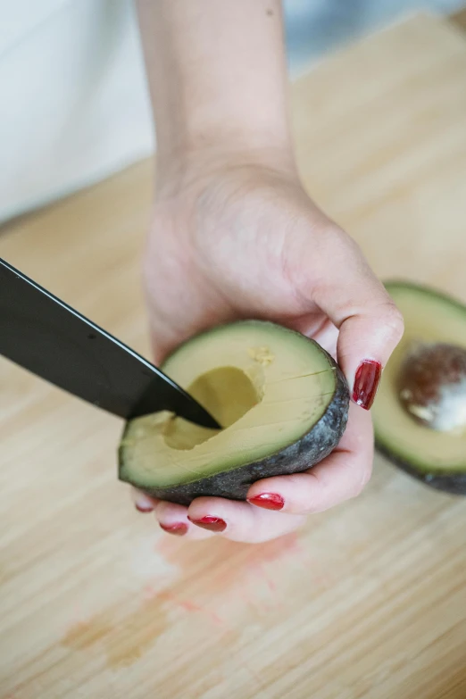 woman  up an avocado on the counter