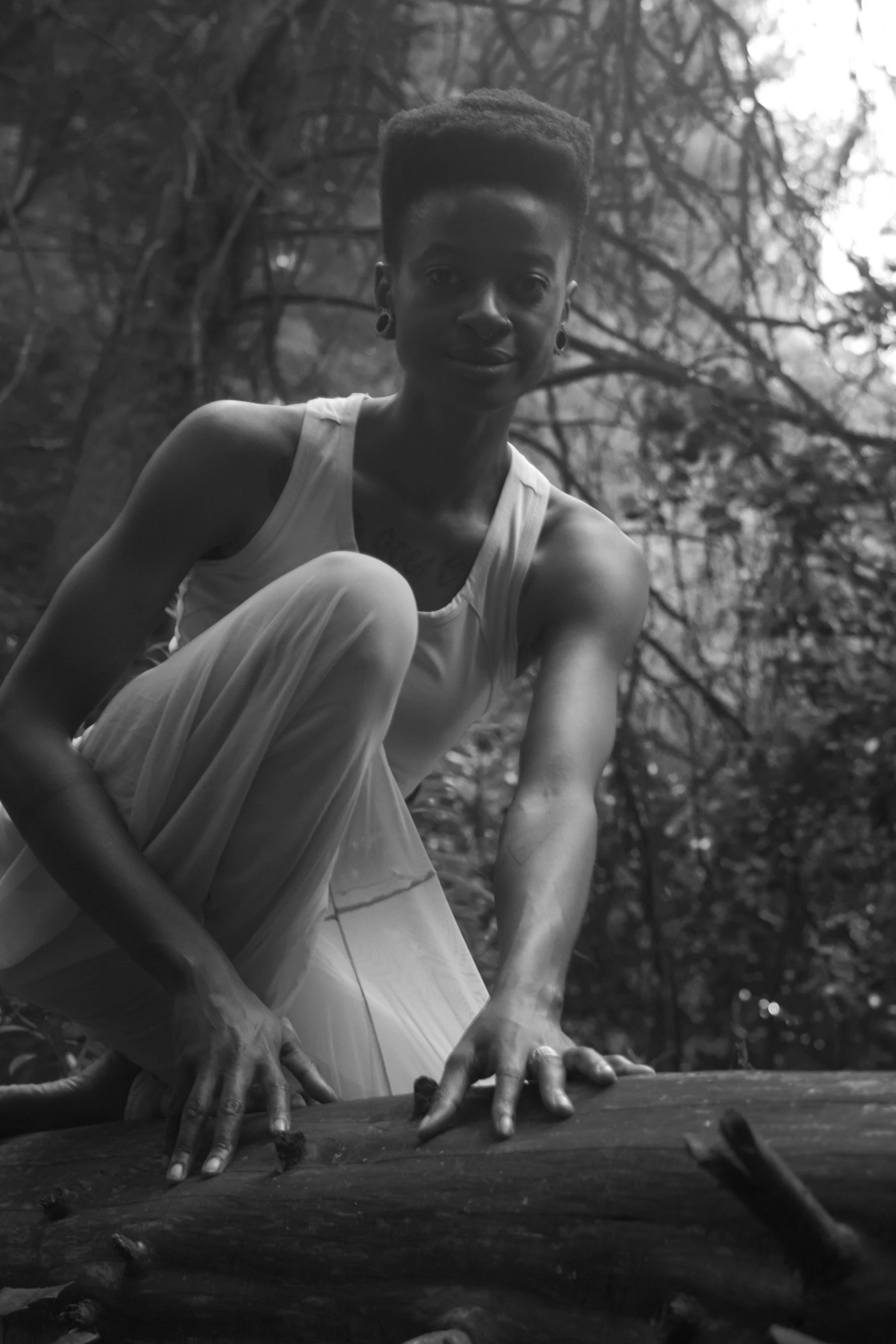 an african american man is posing in the woods