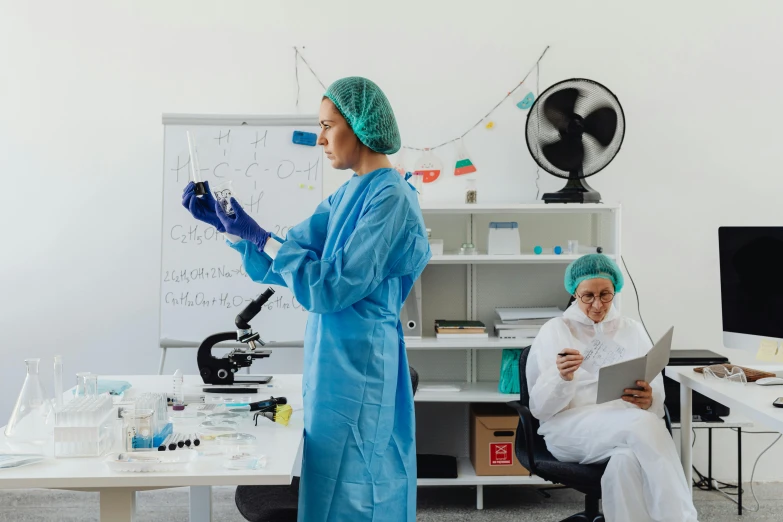 a woman in a blue gown stands in front of an employee