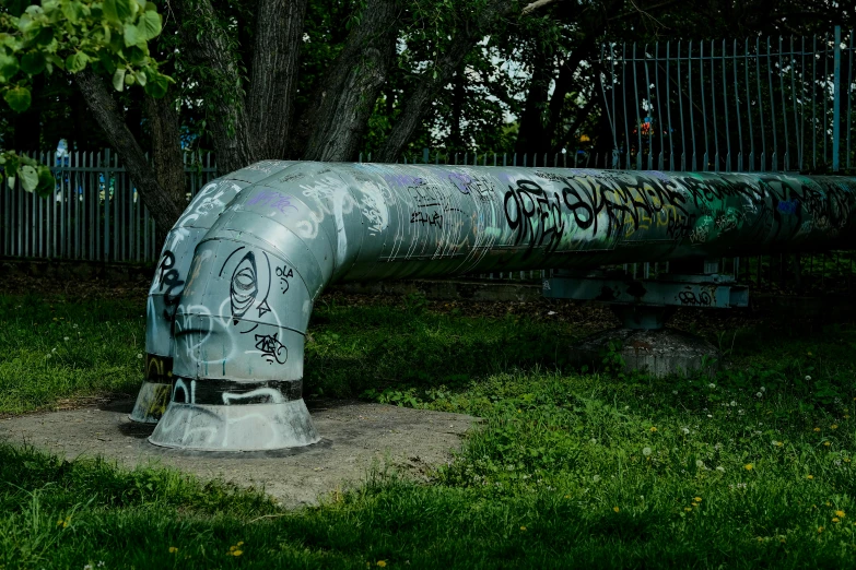 there is a metal pipe with graffiti on it