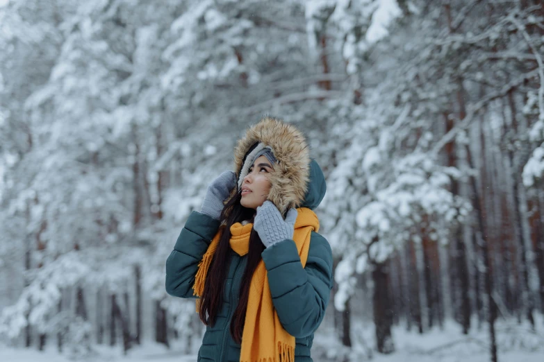 a woman wearing a blue and yellow jacket talking on her phone