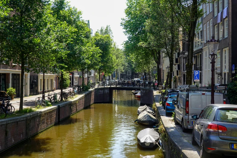 a small canal running through an urban neighborhood