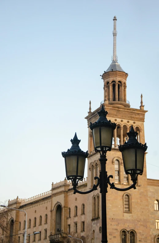 light post and street lamps in front of an old building