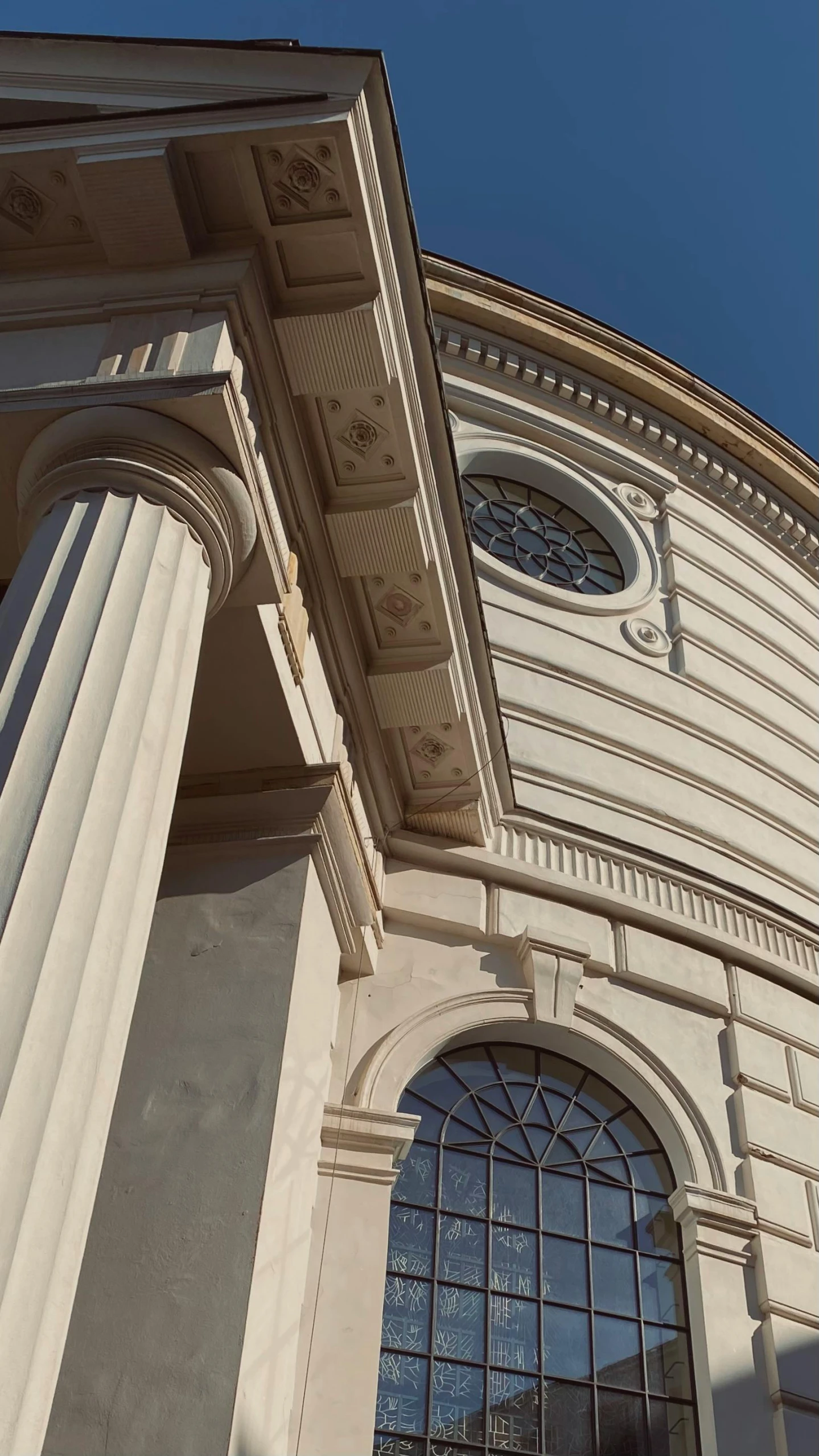 an ornate building with two windows and pillars