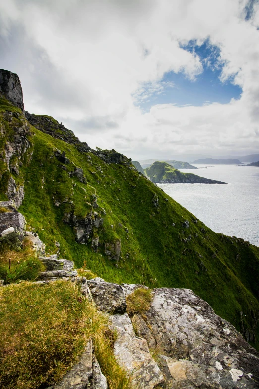 a grassy hillside with some water near it