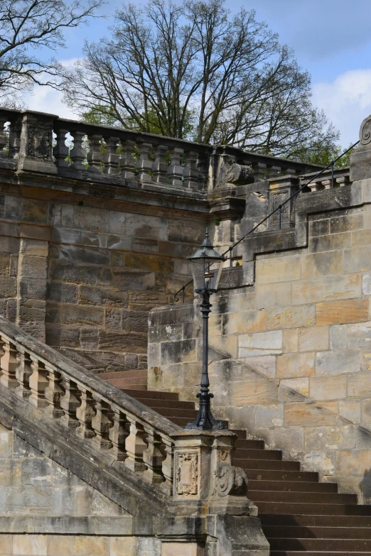 a lamppost outside of an old stone building