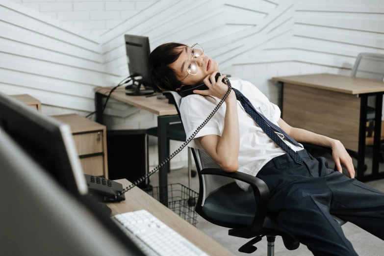 a woman on the phone while seated in an office chair