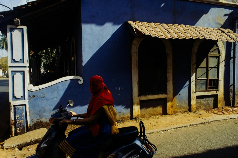 a woman is riding her bike down the street