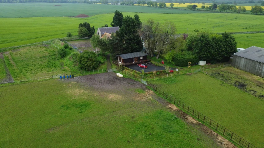 an aerial view of a farm, including some buildings