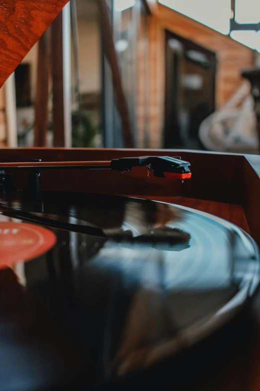 there is a vinyl disc player that has been set on the table