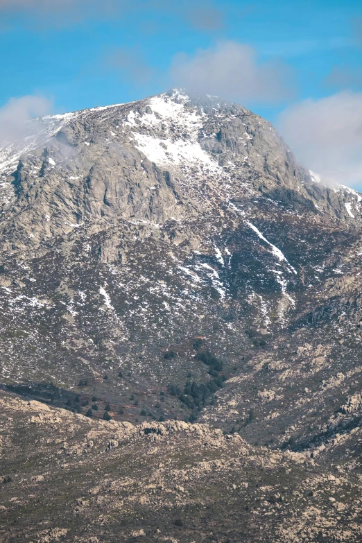 a mountain view with snow covered mountains in the distance