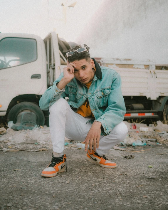 a man kneeling down next to a dump truck