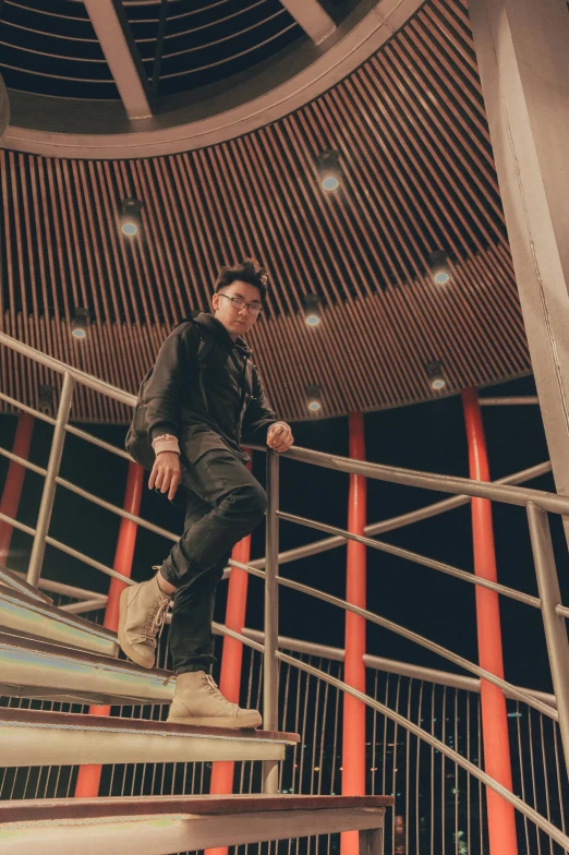 a man stands on top of a stair case