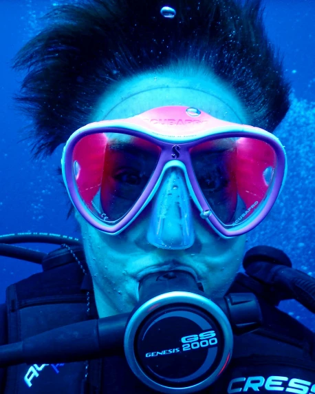 a person with scuba goggles on under water