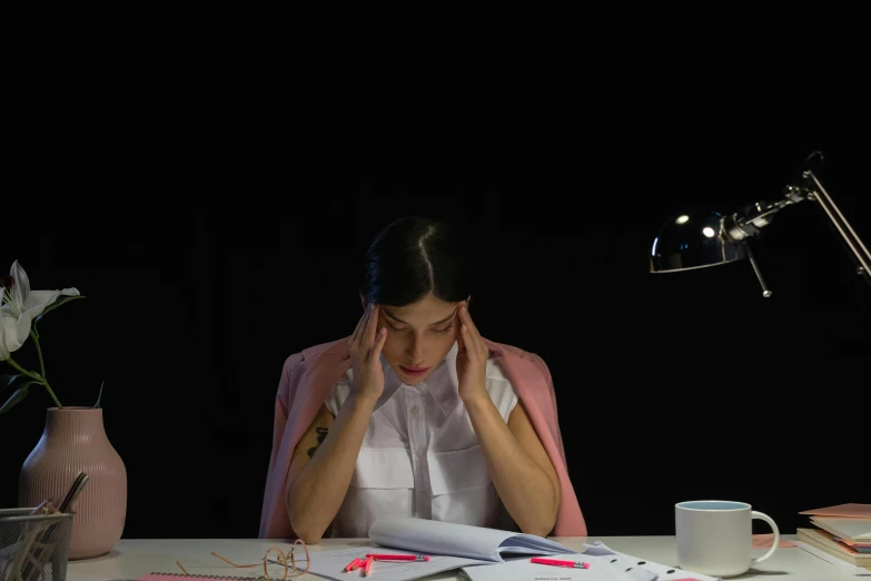 a woman looks at her work on her laptop