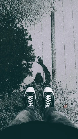 a black and white image of someone with his shoes on