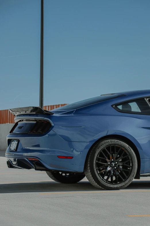 an exotic blue sports car parked in the parking lot