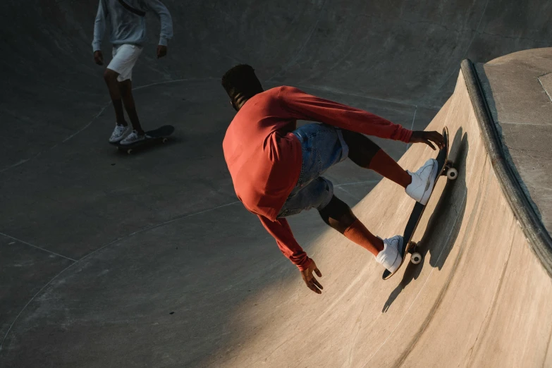 two skateboarders skating around a small cement ramp