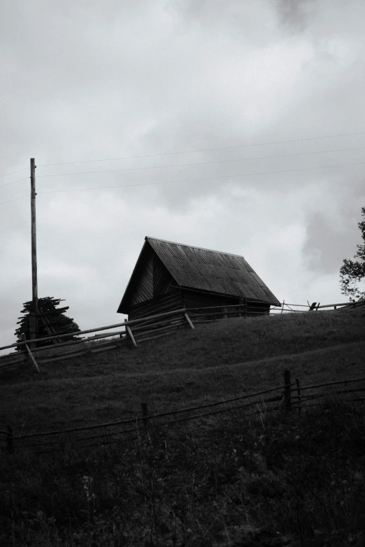 a large wooden barn on top of a hill