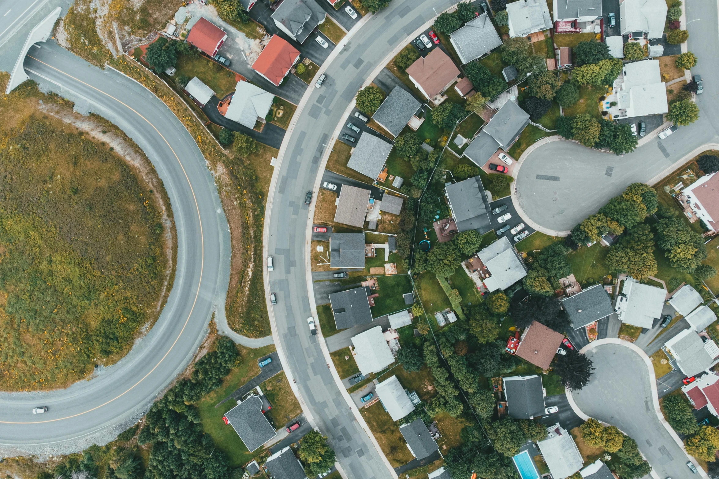 aerial s of an intersection with houses and roads