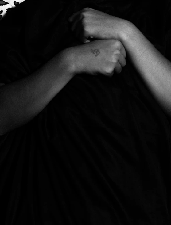 black and white pograph of two hands hugging