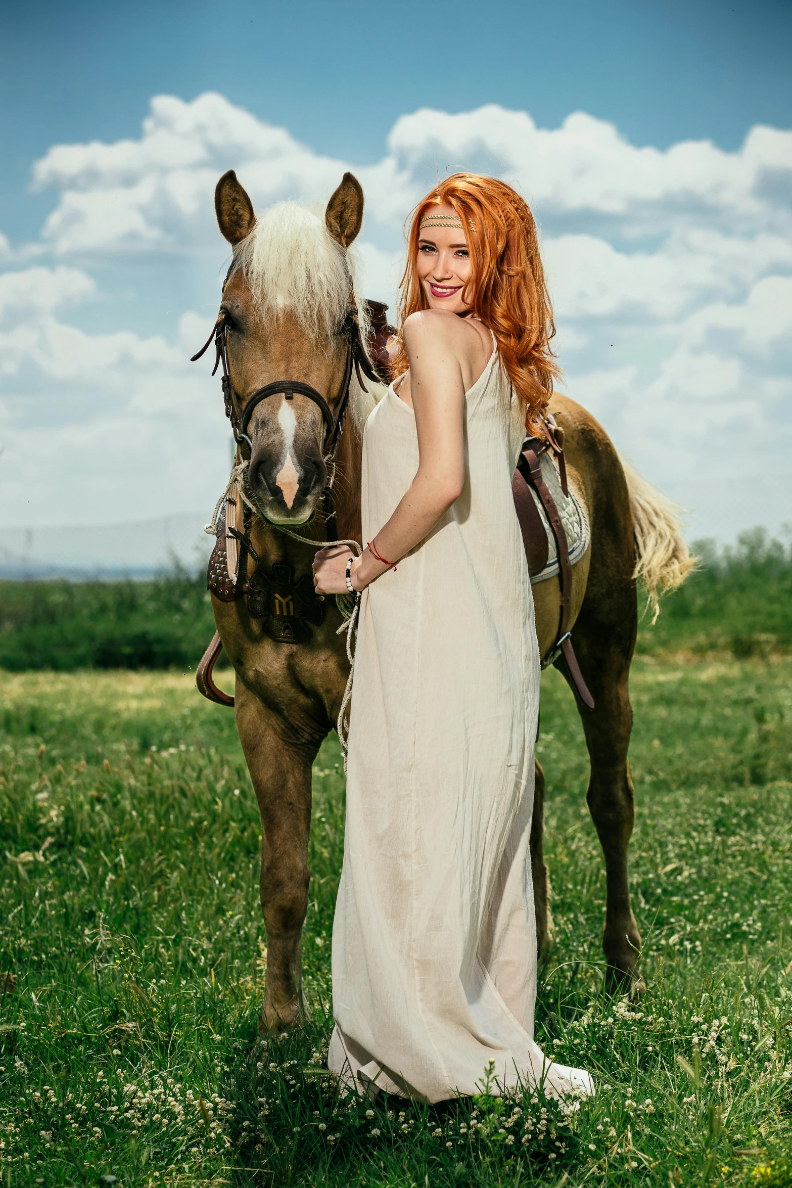 a girl wearing a dress posing with a horse