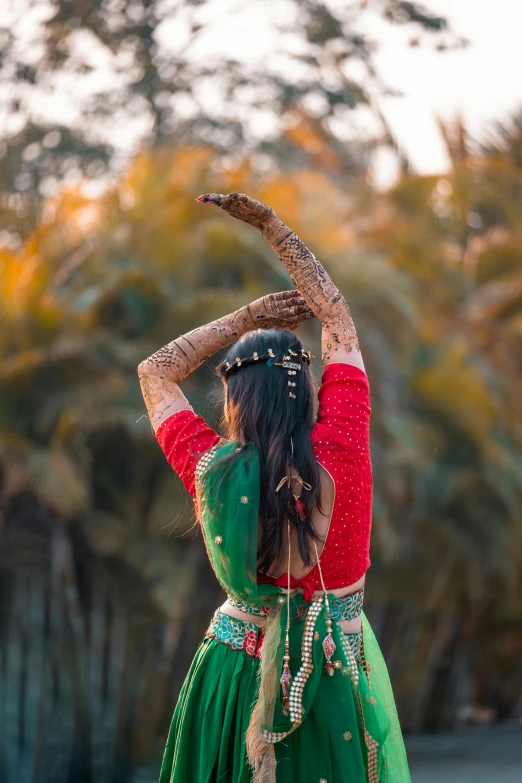 the girl is wearing an elaborate green and red outfit