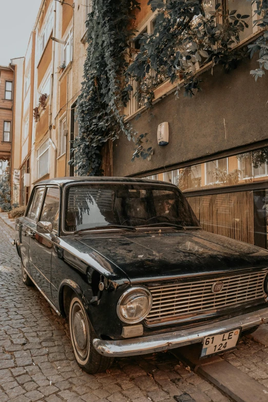 a black old car parked in front of a building